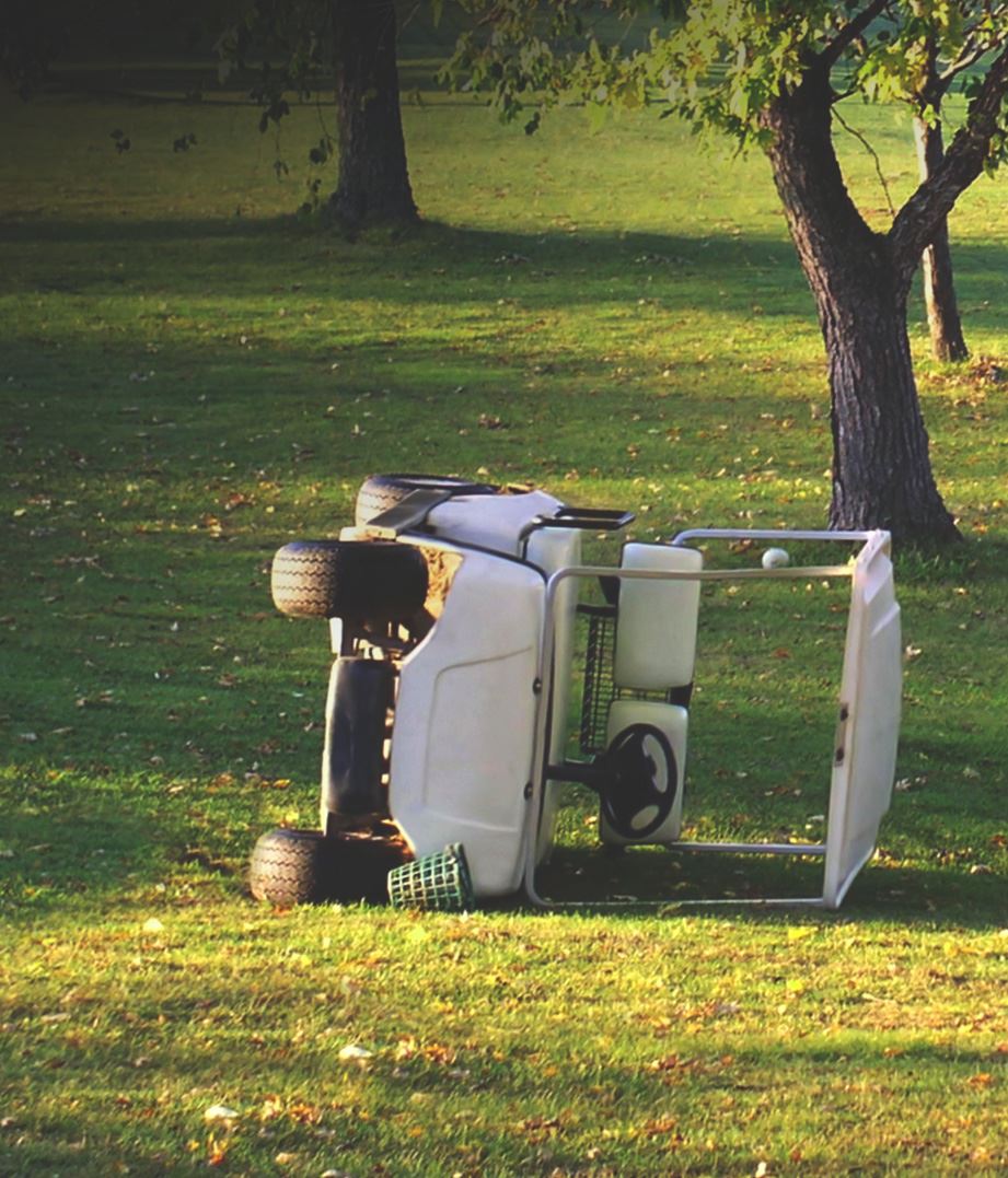 Golf cart that is tipped over on its side