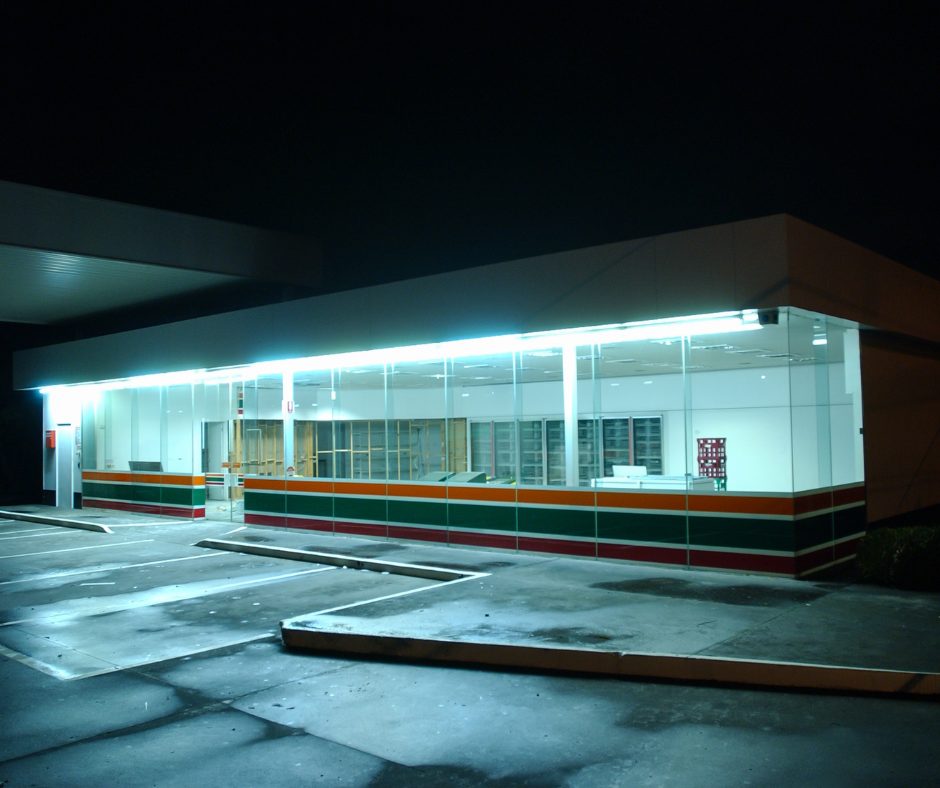 Front of an empty convenience store, the parking lot is empty.