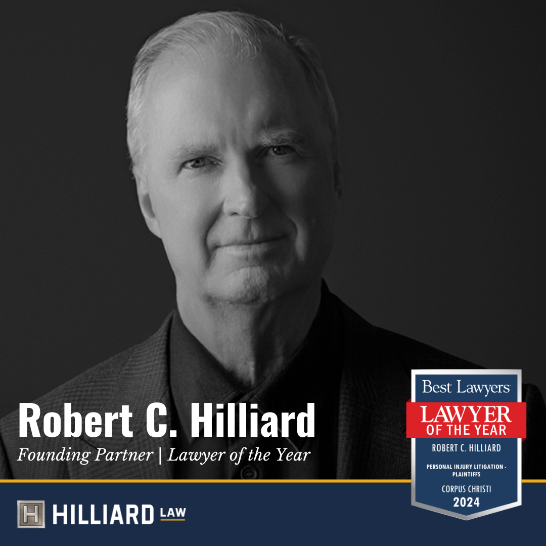 Image is in black and white. It is a close up shot of Bob Hilliard, a Caucasian attorney. He is wearing a dark shirt and dark jacket. There is an emblem on the lower right corner that reads "Best Lawyers, Lawyer of the Year, Robert C. Hilliard, Personal Injury Litigation - Plaintiffs, Corpus Christi, 2024". There is a HIlliard Law logo in the bottom left corner.