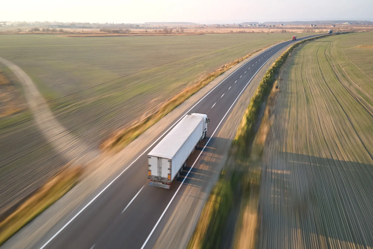 Aerial view of a truck driving on a highway.